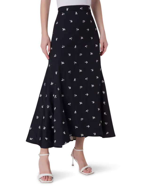 تنورة طويلة من قماش الجاكار بقصة ضيقة من الأعلى وواسعة من الأسفل مزينة بزهور صغيرة