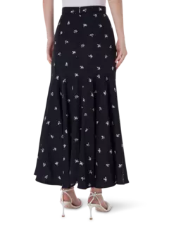 تنورة طويلة من قماش الجاكار بقصة ضيقة من الأعلى وواسعة من الأسفل مزينة بزهور صغيرة